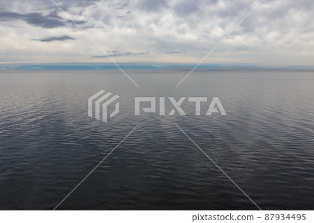 Evening on Lake Baikal. Cloudy sky and water. Evening on Lake Baikal. Cloudy sky and water. 87934495