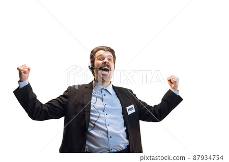 Emotive young man, professional sport commentator, journalist with microphone broadcasting football match isolated over white background. Sport, news concept Emotive young man, professional sport commentator, journalist with microphone broadcasting football match isolated over white background. Sport, news concept 87934754