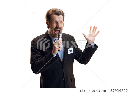 Emotive young man, professional sport commentator, journalist with microphone broadcasting football match isolated over white background. Sport, news concept 87934802