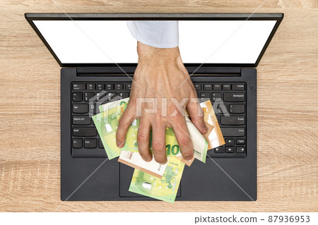 Hand reaching out of laptop screen to steal money Hand reaching out of laptop screen to steal money 87936953