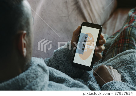 smartphone with text fomo, fear of missing out smartphone with text fomo, fear of missing out 87937634