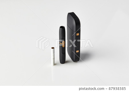 New generation black electronic cigarette, battery and one heatstick isolated on white. Hi-tech heating tobacco system. New technology. Close up 87938385