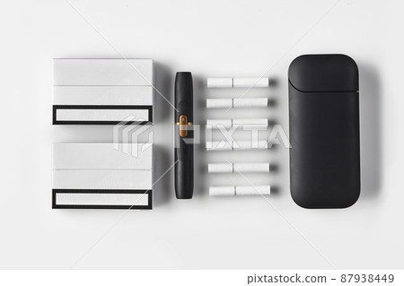 New generation black electronic cigarette and battery, two packs and six heatsticks isolated on white. Heating tobacco system. Close up, flat lay New generation black electronic cigarette and battery, two packs and six heatsticks isolated on white. Heating tobacco system. Close up, flat lay 87938449