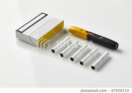 New generation black and yellow electronic cigarette, pack and five heatsticks isolated on white. Advertising area. Heating tobacco system. Close up 87938519