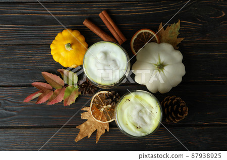Glasses of pumpkin latte and ingredients on rustic wooden background 87938925