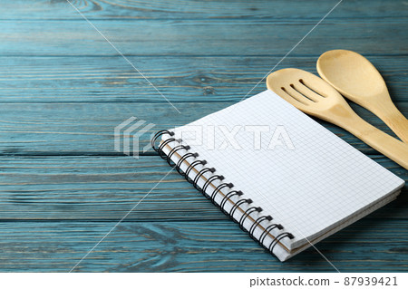 Empty recipe book and utensils on wooden table 87939421