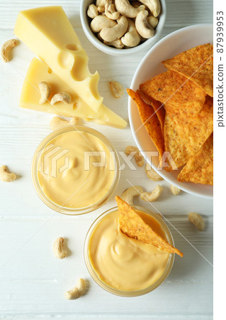 Snacks with cheese sauce on white wooden table Snacks with cheese sauce on white wooden table 87939953