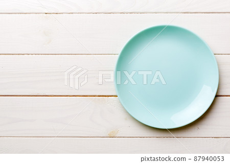 Top view of empty blue plate on wooden background. Empty space for your design Top view of empty blue plate on wooden background. Empty space for your design 87940053
