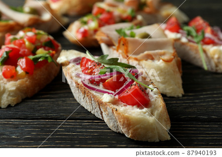 Delicious italian snacks bruschetta on wooden background Delicious italian snacks bruschetta on wooden background 87940193