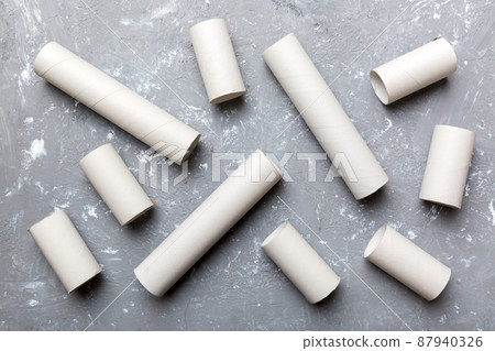 Empty toilet paper roll on colored background. Recyclable paper tube with metal plug end made of kraft paper or cardboard Empty toilet paper roll on colored background. Recyclable paper tube with metal plug end made of kraft paper or cardboard 87940326