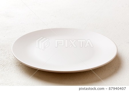 Perspective view of empty light plate on cement background. Empty space for your design 87940407