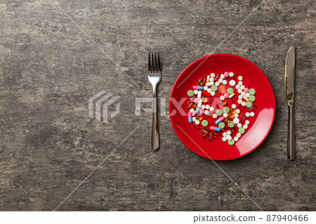 Many different weight loss pills and supplements as food on round plate. Pills served as a healthy meal. Drugs, pharmacy, medicine or medical healthycare concept Many different weight loss pills and supplements as food on round plate. Pills served as a healthy meal. Drugs, pharmacy, medicine or medical healthycare concept 87940466