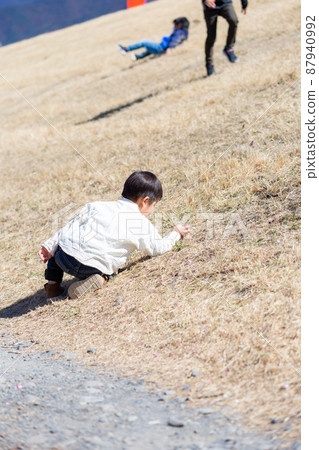 Boy playing on the riverbed 87940992