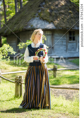 Woman in traditional clothing posing on nature in village. Woman in traditional clothing posing on nature in village. 87941204