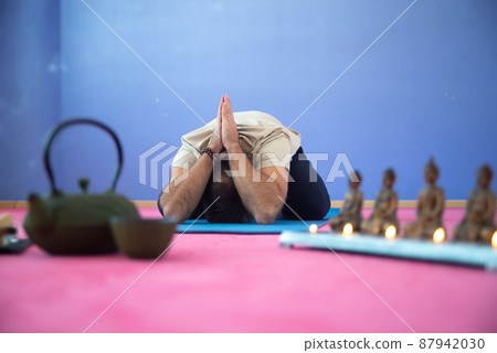 Spiritual man meditating in empty room Spiritual man meditating in empty room 87942030