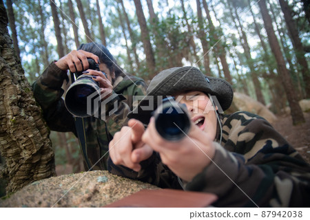 Joyful family taking pictures in forest 87942038