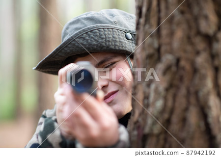 Boy with camera in forest Boy with camera in forest 87942192