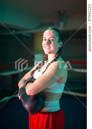 Portrait of happy girl standing on boxing ring 87942223