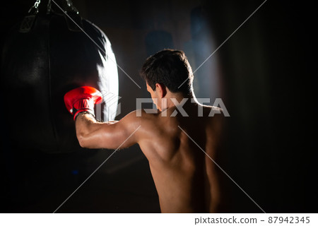 Dedicated sportsman punching boxing bag Dedicated sportsman punching boxing bag 87942345