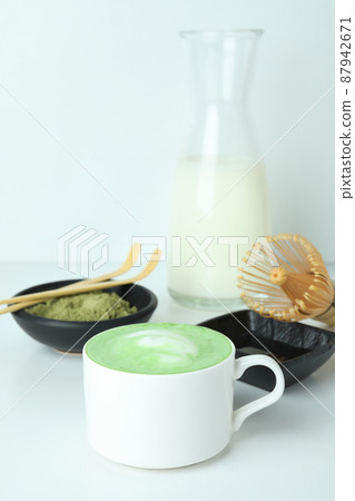 Matcha latte and accessories for making on white table 87942671