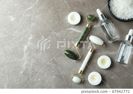 Skin care concept with face rollers on gray textured table 87942772