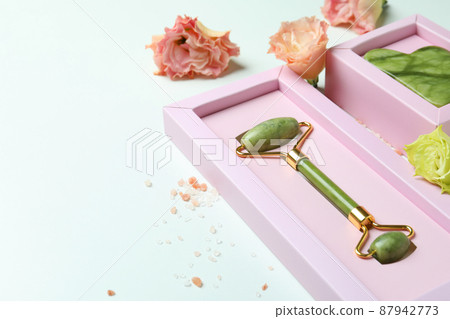 Skin care concept with face roller and gua sha on white background 87942773