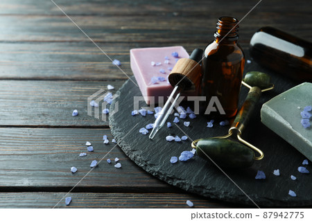 Skin care concept with face roller on rustic wooden table Skin care concept with face roller on rustic wooden table 87942775