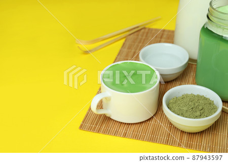 Matcha latte and accessories for making on yellow background Matcha latte and accessories for making on yellow background 87943597