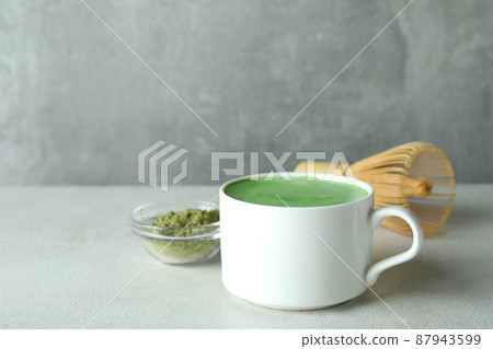 Matcha latte and accessories for making on white textured table Matcha latte and accessories for making on white textured table 87943599