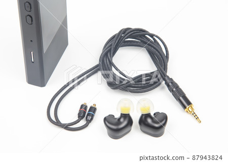 In-ear headphones for Hi-Fi music player. Audio sound and modern equipment In-ear headphones for Hi-Fi music player. Audio sound and modern equipment 87943824
