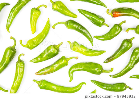 green hot peppers evenly spread on a white background. vitamin vegetables for health green hot peppers evenly spread on a white background. vitamin vegetables for health 87943932
