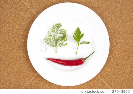 Fresh red hot peppers on a white plate. Vitamin wholesome food. Fresh red hot peppers on a white plate. Vitamin wholesome food. 87943933