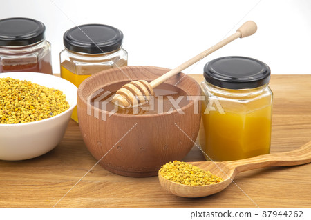 Fresh flower honey in a wooden bowl, spoon, pollen. vitamin food for health and life Fresh flower honey in a wooden bowl, spoon, pollen. vitamin food for health and life 87944262
