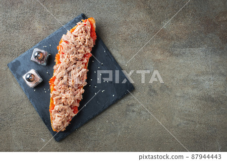 Traditional Spanish breakfast. Tostada with different toppings on a dark background. Top view with copy space 87944443
