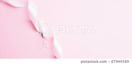 Tampon woman feminine hygiene. Pink ribbon with menstrual tampon on pink background. Menstruation feminine period. Soft tender protection for women critical days. Tampon woman feminine hygiene. Pink ribbon with menstrual tampon on pink background. Menstruation feminine period. Soft tender protection for women critical days. 87944589