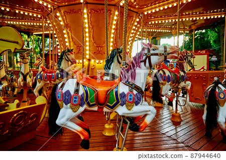 Horse carousel at amusement park 87944640