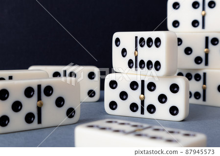 Classic domino chips on a gray background. The concept of free time. Game. 87945573
