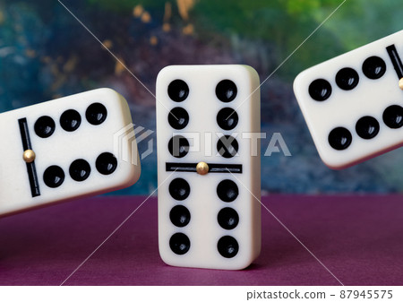 Classic domino chips on a multicolored background. The concept of free time. Game. 87945575
