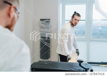 carpenters working with wood on the planing machine carpenters working with wood on the planing machine 87947418