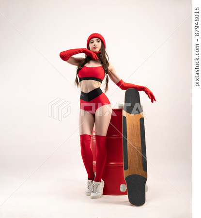 a girl in a red hat with a longboard in short red sports summer clothes on a white background a girl in a red hat with a longboard in short red sports summer clothes on a white background 87948018
