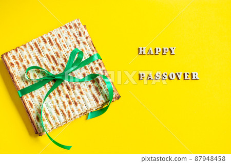 Celebrating the traditional Jewish holiday of Passover. Matzo on a yellow background. Pesach matzah. Celebrating the traditional Jewish holiday of Passover. Matzo on a yellow background. Pesach matzah. 87948458