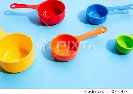 Measuring Spoons on blue background. Measuring Spoons on blue background. 87949173