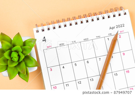 April 2022 desk calendar with wooden pencil. 87949707