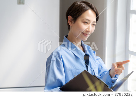 Female remodeling inspection of work clothes 87950222