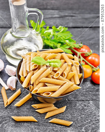 Penne whole grain in bowl with vegetables on table 87953263