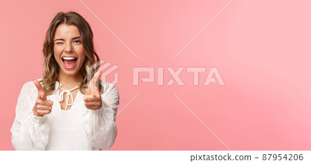 Close-up portrait of sassy and carefree good-looking emotive blond girl, pointing finger pistols at camera as asking join her team, become member, inviting try product yourself, smiling cheeky Close-up portrait of sassy and carefree good-looking emotive blond girl, pointing finger pistols at camera as asking join her team, become member, inviting try product yourself, smiling cheeky 87954206