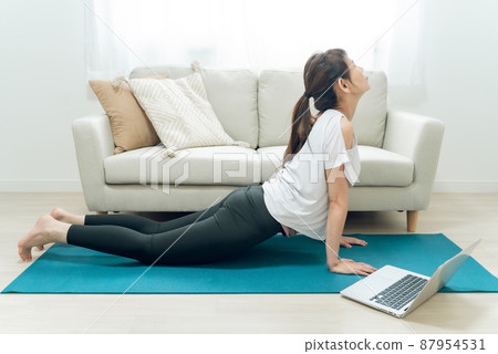 Middle-aged and older women doing online yoga (cobra pose) Middle-aged and older women doing online yoga (cobra pose) 87954531