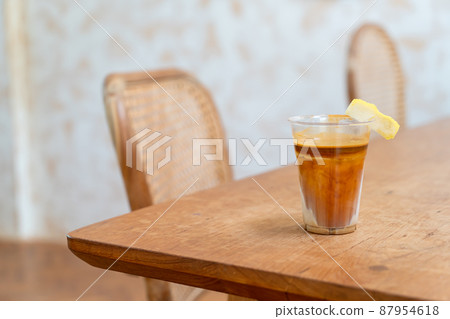 Specialty coffee menu called 'Dirty coffee' . Cold milk in the bottom with hot espresso shot on top Specialty coffee menu called 'Dirty coffee' . Cold milk in the bottom with hot espresso shot on top 87954618