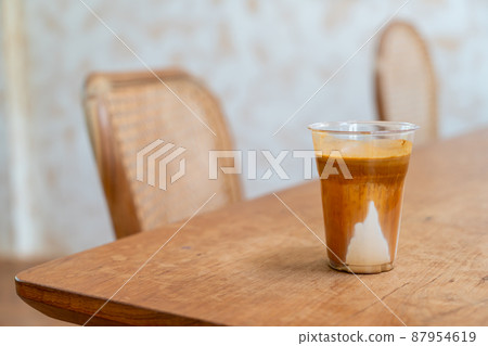Specialty coffee menu called 'Dirty coffee' . Cold milk in the bottom with hot espresso shot on top Specialty coffee menu called 'Dirty coffee' . Cold milk in the bottom with hot espresso shot on top 87954619