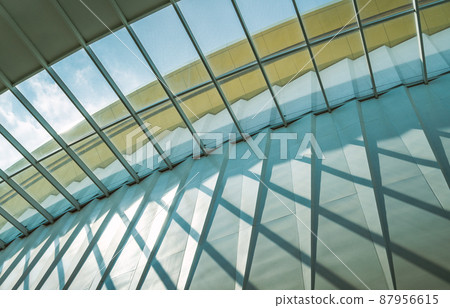 Abstract pattern of building structure of glass ceiling, light and shadow, worm eye view image, day light from sky. 87956615